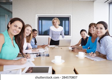 Group Of Businesswomen Meeting Around Boardroom Table