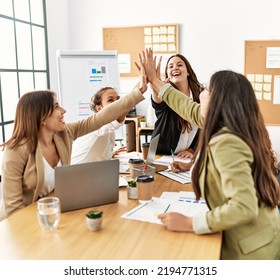 Group of businesswomen smiling happy celebrating high five at the office. - Powered by Shutterstock