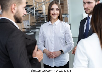 Group Of Busy Business People Concept. Business Team Discussing Work In Office Building Hallway