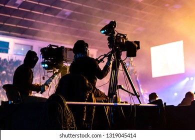 A group of cameramen working during the concert.