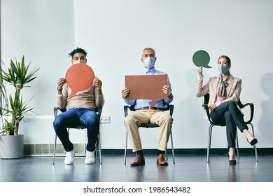 Group Of Candidates Holding Speech Bubbles While Waiting For Job Interview During Coronavirus Pandemic. Copy Space.