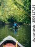 Group of Canoers paddling down a river in Pembrokeshire 