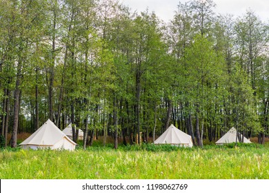 Group Of Canvas Bell Tents At Forest