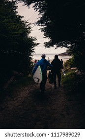 A Group Carrying Their Surf Boards To The Beach. Bright And Sunny Day In Tofino BC. 