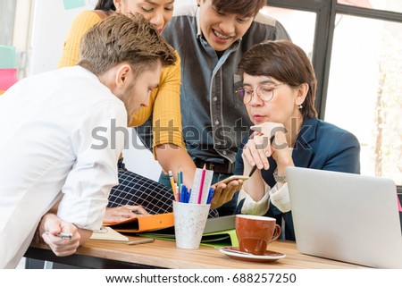 Group of casual business meeting to discuss ideas and computer  on table in office.