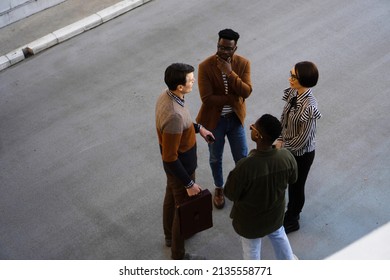 Group Of Casual Business People Standing And Talking Outside