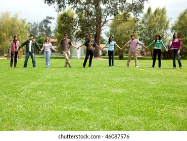 Group Of Casual People Outdoors Holding Hands