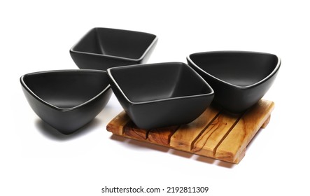 Group Ceramic Black Empty Bowl And Wooden Pot Holder Isolated On White 