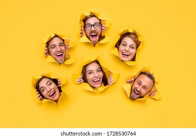 Group of cheerful diverse men and women peeking out from holes in bright yellow paper and looking at camera in excitement