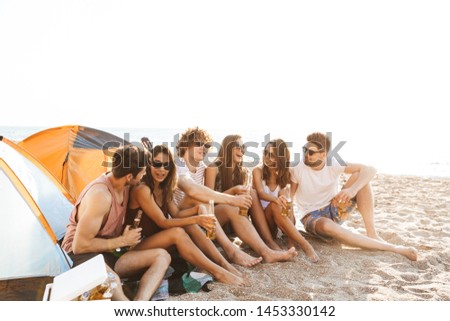 Similar – Young friends holding woman on top of surfboard