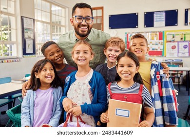 Group of cheerful multiethnic kids standing and posing for a photograph with male teacher at the end of the school year. Portrait of enthusiastic male teacher with his primary students in classroom. - Powered by Shutterstock