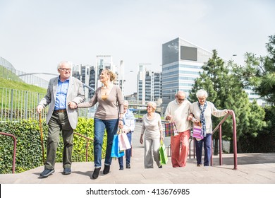 Group Of Cheerful Pensioners Having A Walk Outdoors And Shopping In City Centre - Senior Group Of Friends Bonding And Having Fun