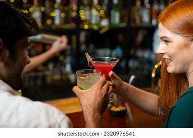 Group of Cheerful people friends celebrating holiday event hanging out party drinking alcoholic cocktail together at restaurant bar. Man and woman enjoy and fun hangout meeting nightlife at nightclub.