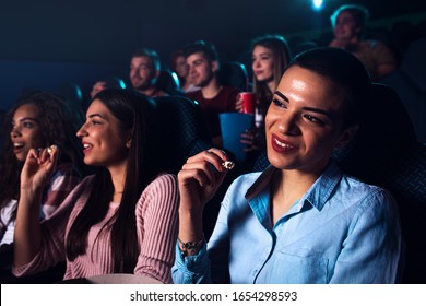 Group Of Cheerful People Laughing While Watching Movie In Cinema.