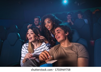 Group Of Cheerful People Laughing While Watching Movie In Cinema.