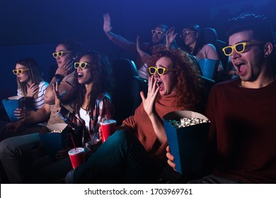 Group Of Cheerful People Laughing While Watching Movie In Cinema With 3D Glasses.