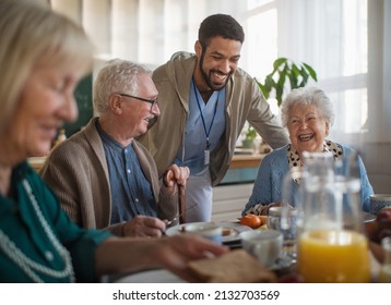 Group of cheerful seniors enjoying breakfast in nursing home care center. - Powered by Shutterstock