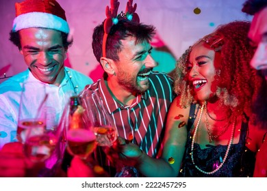 Group of cheerful young friends having fun dancing, making a toast and drinking champagne at New Year party midnight countdown - Powered by Shutterstock