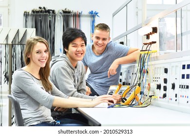 Group Of Cheerful Young Students In Vocational Education And Training For Electronics 