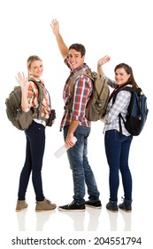 Group Of Cheerful Young Tourists Waving Goodbye Isolated On White