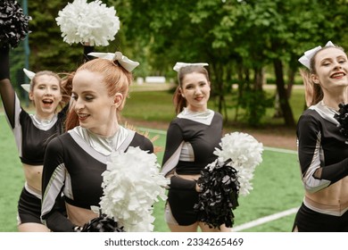 Group of cheerleading girls dancing outdoors - Powered by Shutterstock