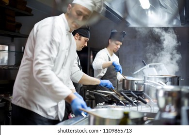 Group of chefs working in the kitchen - Powered by Shutterstock