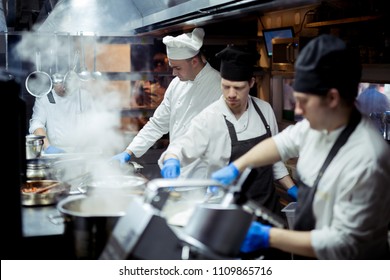 Group of chefs working in the kitchen - Powered by Shutterstock