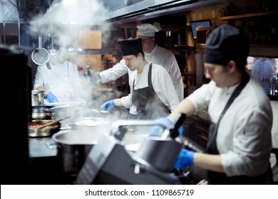 Group Of Chefs Working In The Kitchen