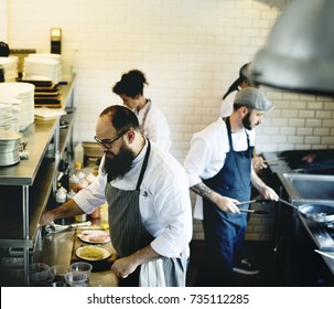 Group Of Chefs Working In The Kitchen