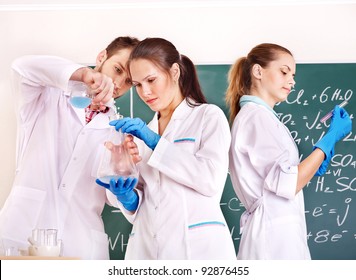 Group Chemistry Student With Flask In Classroom.