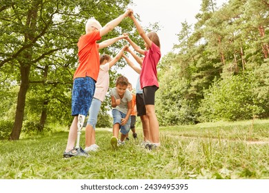 Group of children at birthday party outdoors playing games in summer - Powered by Shutterstock