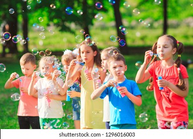 Group of children blowing soap bubbles - Powered by Shutterstock