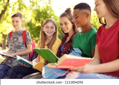 Group Of Children With Books Outdoors. Summer Camp