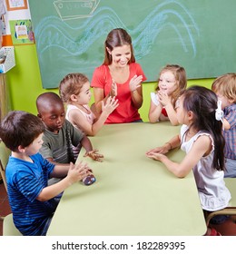Group Of Children Clapping Hands In Kindergarten In Musical Education Class