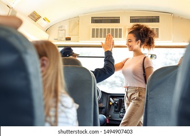 Group of children classmates going to school by bus african girl walking into giving high five to driver smiling happy - Powered by Shutterstock