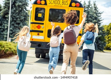 Group Of Children Classmates Running To School Bus Being Late Back View Motion