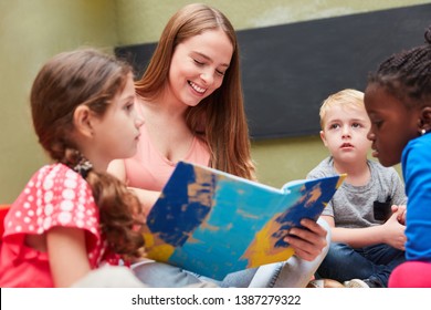 Group of children and educators reading from a children's book or storybook - Powered by Shutterstock