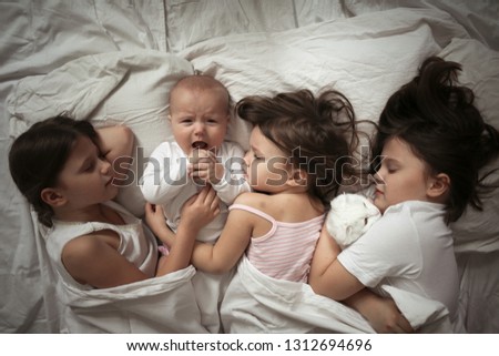 Similar – Little girl embracing doll lying over the bed