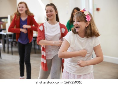 Group Of Children Enjoying Dance Lesson At Stage School Together - Shutterstock ID 1697259310