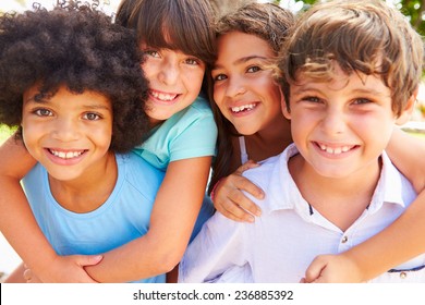 Group Of Children Giving Each Other Piggyback Rides - Shutterstock ID 236885392