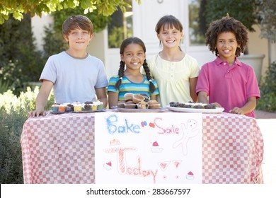 Group Of Children Holding Bake Sale