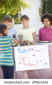 Group Of Children Holding Bake Sale