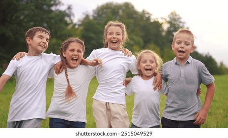 a group of children jumping in the park on the grass embracing. happy family childhood dream concept. little kids jump hugging each other by the shoulders. children lifestyle smiling and laughing - Powered by Shutterstock