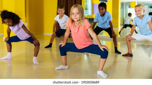 Group Of Children Participating In Dance Class, Following Their Teacher In Dance School.