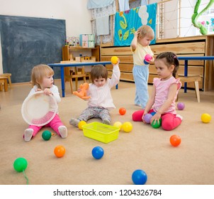 Group Of Children Playing Balls In Kindergarten Or Daycare Centre