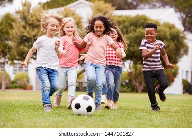 Group Of Children Playing Football With Friends In Park - Powered by Shutterstock