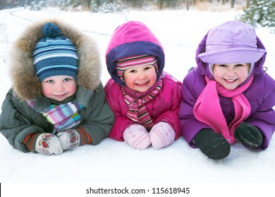 Group Of Children Playing On Snow In Winter Time