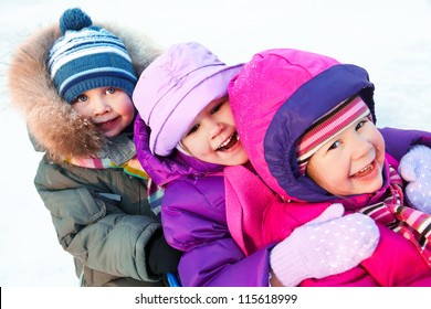 Group Of Children Playing On Snow In Winter Time