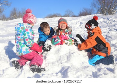 Group Of Children Playing On Snow In Winter Time