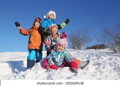 Group Of Children Playing On Snow In Winter Time